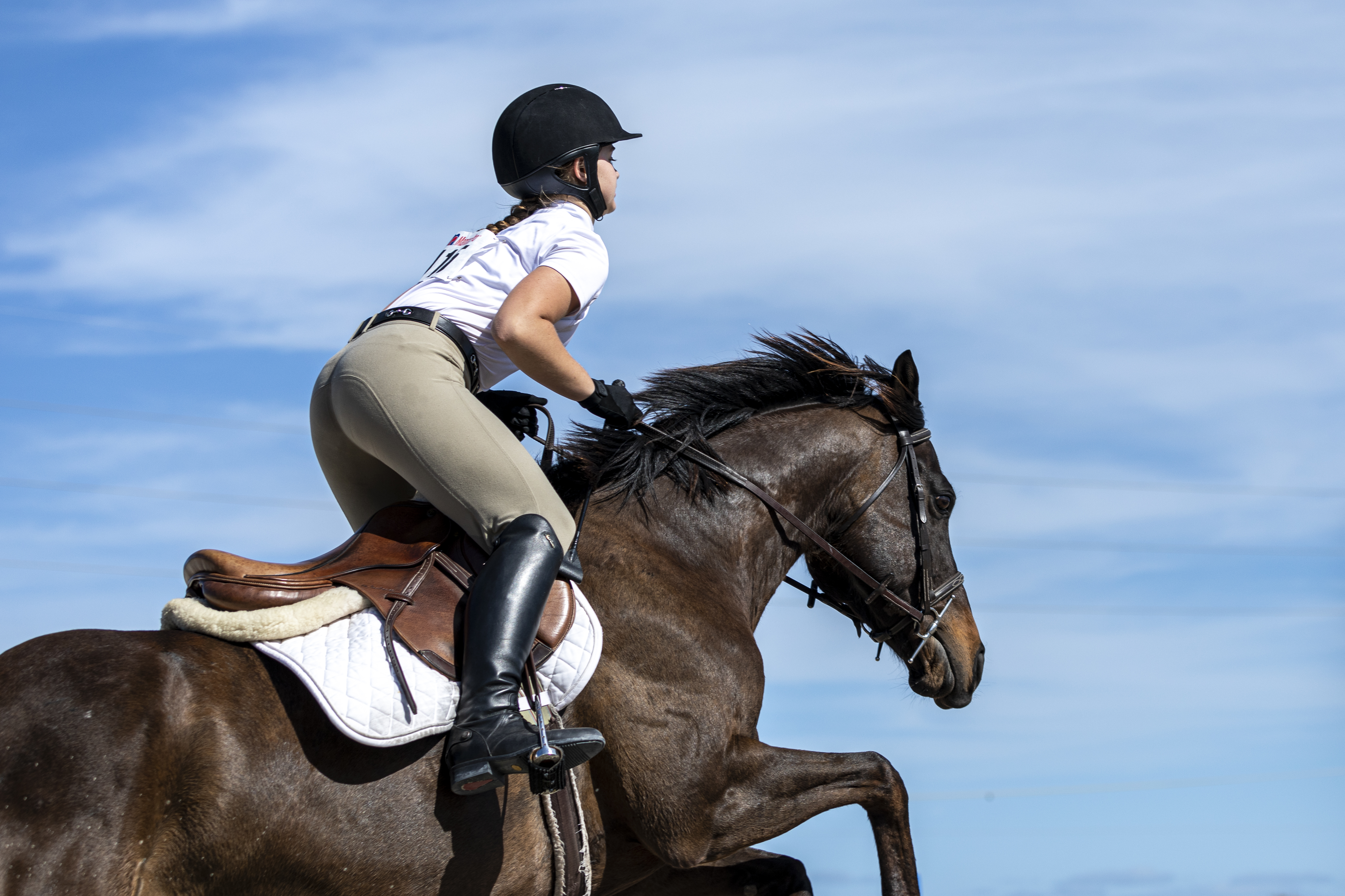 Brevard Equestrian Center participant in jump position on her horse during an equestrian show in 2021.